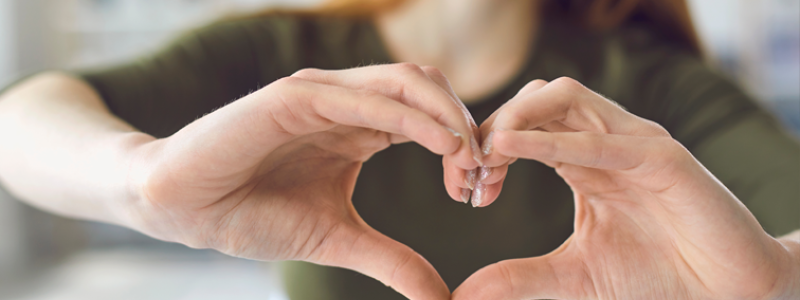 Woman framing a heart with her hands