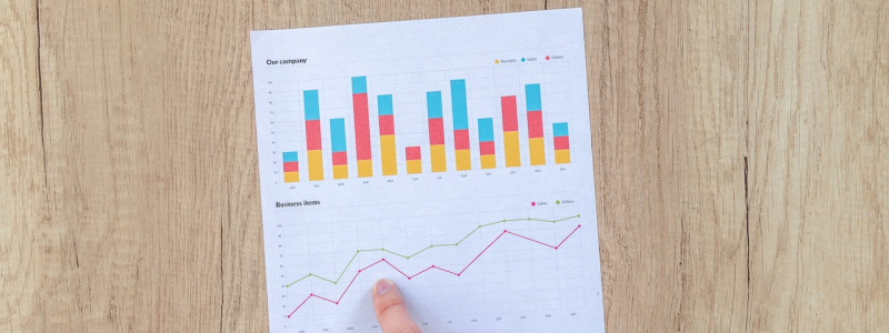 Finger pointing at an upward trending chart